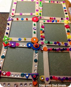 a close up of a board game with buttons and pins on the boards in different colors