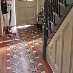 an entryway with stairs and tiled flooring