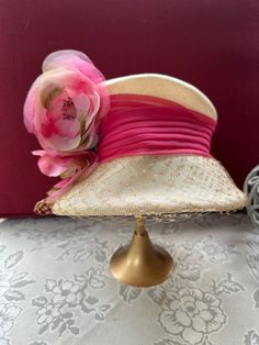 Vintage 1950's era women's hat Purchased from the Halle Bros. Department store of Cleveland, Ohio. Size: 6 3/8 (Head circumference of roughly 20.25") Manufacturer: Union Made      United Hatters - Cap and Millinery Workers Union Made Bucket style: cream woven fabric with pink chiffon ribbon trim; coordinating pink silk flowers and greenery with beige netting on brim. Excellent condition and extremely clean. Steams well with hand held steamer to remove any wrinkles and to re-shape. This is a sweet little hat that is made to sit higher on one's head, rather than pulled down. Perfect for a wedding, church, a baby shower, afternoon tea, or wine tasting! Dress it up with a pretty sundress, or dress it down with your favorite jeans and classic white button up. This gorgeous topper will steal the Kentucky Derby Short Brim Lined Hat, Vintage Fedora One Size Fits Most, Vintage Brimmed Mini Hats For Kentucky Derby, Vintage Mini Hat With Flat Brim For Kentucky Derby, Retro Short Brim Mini Hats For Church, Retro Mini Hats With Short Brim For Church, Vintage Flat Brim Kentucky Derby Hat, Vintage Cloche Hat For Kentucky Derby, Vintage Brimmed Fedora For Party