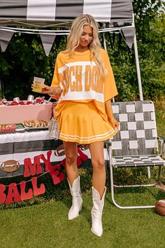 - Show off your team spirit in this dazzling oversized 'TOUCHDOWN' tee! Featuring a sequined design and chic unfinished seam accents, you'll shine on game day. - Unlined lightweight material with unfinished seam accents - A sequined 'TOUCHDOWN' design across the front - Short drop sleeves - An oversized silhouette that ends in an unfinished hemline - This piece is perfect for fans of Tennessee, Texas, Oklahoma State, Florida, and more! Measurements S : Bust 56", Hip 55", Length 25", Sleeve Lengt School Spirit T-shirt For Cheerleading In Fall, Collegiate Summer Tops For Cheerleading, Sports Fan Tops For Game Day In Spring, Sports Fan Tops For Game Day In Summer, Collegiate Summer Fan Gear Tops, Collegiate Style Summer Fan Gear Tops, Collegiate Style Tops For Game Day In Summer, Summer Game Day T-shirt With Team Name, Team Name T-shirt For Game Day In Summer