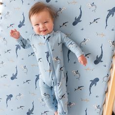 a baby laying on top of a blue sheet