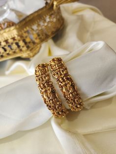 This pair of Indian bangles are perfect blend of modern luxury and traditional style. These bangles are beautifully handcrafted with utmost precision and skill. Our designers have spent hours on this piece to meet your special occasion needs. It is perfect choice for brides, pair this with your rest of the jewelry for a complete royal look. Details & Specifications: Materials used: Brass with antique matte finish Bangle Photography, Simple Gold Bangle, Indian Bangles, Bangles Indian, Royal Look, Gold Bangle, Gold Bangles, Modern Luxury, Traditional Style