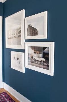 three framed photographs hang on the wall next to each other in a room with blue walls