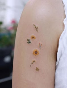 sunflowers and leaves on the back of a woman's left upper arm