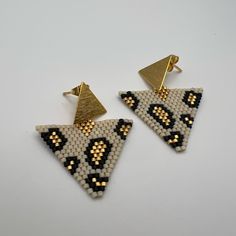 Description: Dainty Triangle Leopard Print Miyuki Earrings These Items Are Individually Made With Love By Me Details: Handmade Item Materials: Miyuki Seeds & 18k Gold Hypo-Allergenic Stainless Steel Posts Includes Rubber Backs Color: Gold, White, & Black Shape: Triangle Dimension: 2” Style: Boho Chic / Animal Print / Stylish Care Instructions: Store Out Of Direct Sunlight And Keep Away From Water. Handmade White Triangle Beaded Earrings, Elegant Triangle Beaded Earrings Gift, Elegant Triangle Beaded Earrings For Gift, Elegant Triangular Beaded Earrings For Gift, Handmade White Beaded Earrings Trendy Style, Handmade Trendy White Beaded Earrings, Trendy White Dangling Bead Earrings, Handmade White Trendy Beaded Earrings, White Triangle Earrings For Gift