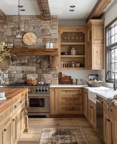 a kitchen with wooden cabinets and stone walls