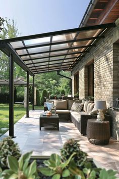 an outdoor living area with couches and tables under a pergolated roof on a sunny day