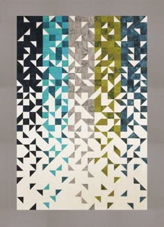 a quilt with many different colors and shapes on it's sides, including triangles