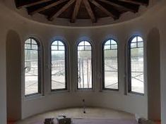 an empty room with three large windows in it