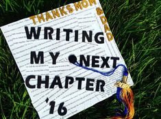 a graduation cap that says writing my next charter 16 is on the grass with a tassel hanging from it