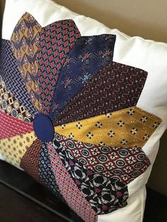 a pillow with many different colored ties on it