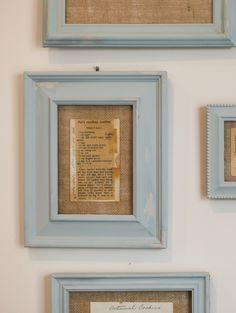 three framed pictures on the wall with an old newspaper page in between two blue frames