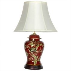 a red and gold vase lamp with a white shade