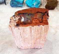 a piece of wood sitting on top of a table next to other rocks and stones