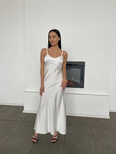 Our V-neck slip dress is made of tender silk and polyester blend. It hits at ankle and has a fitted upper part and a bit flare bottom, and adjustable shoulder straps.  - not lined - thick fabric, not see-through - length without shoulder straps is 46,4 inches or 118 cm - delicate or hand wash cycle, temperature should not exceed 40 C - do not bleach and do not tumble dry SIZES 4 sizes XS = 2 US numeric BUST 33 inches or 84 cm WAIST 24 inches or 63 cm HIPS 36 inches or 92 cm S = 4 US numeric BUST Chic White V-neck Slip Dress, White V-neck Slip Dress For Wedding, White Satin Evening Slip Dress, White Bias Cut Midi Dress For Wedding, White Satin Midi Dress Bias Cut, White V-neck Bias Cut Maxi Dress, White Bias Cut Slip Dress For Party, White Satin V-neck Maxi Dress, V-neck Slip Dress For Wedding Night