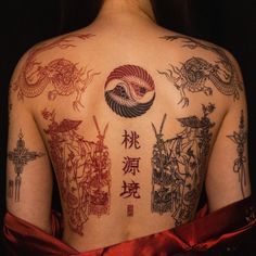 the back of a woman's body with tattoos on it