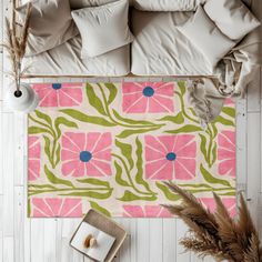 an overhead view of a living room with pink and green rugs