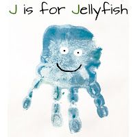 a child's hand with a smiley face drawn on it and the words u is for jellyfish