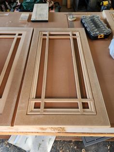 an unfinished cabinet door is being built with plywood and woodworking tools on the table