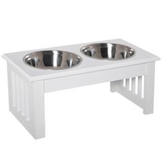 two bowls on a white wooden dog table