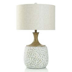 a table lamp with a white shade on it and a light brown base, sitting against a white background