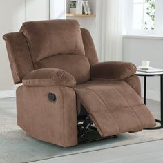 a brown recliner chair sitting on top of a rug