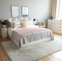 a bedroom with a bed, dresser and two framed pictures on the wall above it