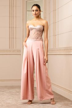 Blush studded and panelled corset with faux diamonds all-over and side criss cross tie-ups. Paired with flared and pleated trouser.
Components:2
Pattern:Embroidered
Type of Work:Faux Diamonds
Neckline:Sweetheart
Sleeve Length:Sleeveless
Fabric:Corset: Indian Tulle, Foil Jersey; Trouser: Banana Crepe
Color:Pink
Other Details:
Sheer back
Side criss cross tie-up
Closure:
Corset: Back zip
Occasion:Party - Aza Fashions Banana Crepes, Saree Jackets, Pink Banana, Pink Trousers, Pink Corset, Tarun Tahiliani, Lehenga Saree, Indian Fashion Designers, Flare Trousers