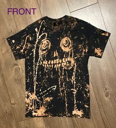 a t - shirt that has been dyed black and yellow with roses on the front