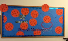 a bulletin board with orange and blue basketballs on it