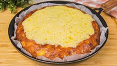 a pan filled with food sitting on top of a wooden table