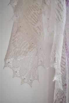 Beautiful lace rectangular shawl is made in Estonian old style with traditional patterns. Very soft, lacy stole made of high quality fine yarn (mohair, silk). Has a light, fluffy texture, very pleasant to the skin. Makes you warm and cozy, yet elegant! Perfect for bridal outfit! Colour: white Size approx : 80 cm x 200 cm -15 cm) Material: 30 % soie 70 % kid mohair One more wedding shawl looking for here https://www.tricoteart.com/listing/572080177/chale-dentelle-romantisme-en-mohair Handmade Lace Shawl In White, Handmade White Lace Shawl, Elegant Hand Knitted Cream Shawl, Elegant Alpaca Shawl Scarf, Elegant Hand Knitted Shawl Scarf, Elegant Hand Knitted Alpaca Shawl, Elegant Hand-knitted Shawl Scarf, White Hand Knitted Shawl For Wedding, Hand Knitted White Shawl For Wedding