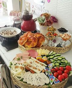 two trays filled with different types of food on top of a white kitchen counter