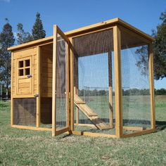 a chicken coop in the middle of a field