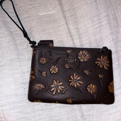 Coach Floral Wristlet, Never Used Brown Clutch With Removable Pouch, Brown Clutch Pouch With Wrist Strap, Brown Pouch With Wrist Strap For Daily Use, Brown Wristlet With Removable Pouch As Gift, Brown Handheld Clutch As Gift, Brown Handheld Clutch As A Gift, Brown Leather Travel Wristlet, Brown Leather Wristlet For Everyday Use, Coach Brown Bag As Gift