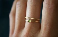 STUNNING handmade peridot ring set✨ * Listing covers both the peridot ring and twisted band. Beautiful 3mm peridot gemstone ✨ Peridot is a crystal that's not only rich in culture and history, but also mysticism and healing power. Peridot is rich with healing energies and spiritual connotations. Peridot can help to boost the confidence of those wearing it, as well as attracting luck and love✨ A beautiful minimalist piece to have in ones collection✨ Perfect for stacking or wearing alone! Material: Gold Stackable Rings With Peridot Birthstone, Dainty Green 14k Gold Stackable Rings, Gold Peridot Stackable Rings As Gift, Gold Stackable Peridot Rings As A Gift, Minimalist Gold Stackable Rings For May Birthstone, Dainty Green Round Midi Rings, Minimalist Gold Stackable Rings With Emerald, Dainty Green Ring For Everyday, Minimalist Green Stackable Rings For Everyday