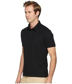 This exclusive Lacoste® Short Sleeve Solid Stretch Pique Regular polo is a must-have for any well-dressed man's wardrobe..Polo crafted from a unicolor stretch cotton piqué..Regular fit sits straight through the shoulders and waist for a casual yet modern finish..Ribbed fold-over collar..Short sleeves with rib trim..Concealed-button placket..Signature crocodile applique at left chest..Straight hem with side vents..94% cotton, 6% elastane..Machine wash cold, hang dry..Made in Peru..Product measurements were taken using size MD. Please note that measurements may vary by size..Measurements: Length: 29 in Sleeve Length: 10 in Solid Cotton Slim Fit Polo Shirt, Lacoste Men, Men's Wardrobe, Well Dressed, Button Placket, Stretch Cotton, Men Dress, Top Shirt, Short Sleeves