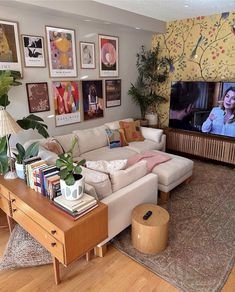 a living room filled with furniture and a flat screen tv sitting on top of a wooden table