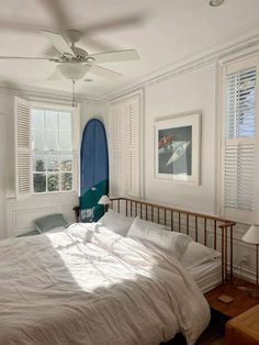 a bedroom with a surfboard mounted to the wall next to it's bed