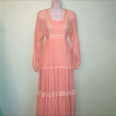 Wow Super Romantic! True Vintage 60’s Maxi Dress By Roberta California Size Tag Is Faded But Measures A Modern Xs/Small. No Fabric Content Tags But This Maxi Is Super Flowy!Peachy Pink Color Bib Style Bust Line Thats Lined In The Center Cream Lace & Satin Ribbon Accents Dolman Sheer-Ish Sleeves Elastic Wrists & Lace Down The Arms Tie Back At The Empire Waist Back Zipper 3 Tier Skirted Portion Skirt Is Fully Lined In A Peach Fabric That Feels Like Thick Rayon. Not The Thicker Taffeta Style Lining Of Some Dresses From This Time Period. Outer Layer Is Soft Light Weight Fabric. My Guess Is Poly/Cotton Blend Cream Crochet Lace Insets Between The Skirt Tiers Measures: Bust: Not Taken Due To S Bridal Dresses Vintage, Peach Fabric, Lace Inset, Time Period, Cream Lace, Peachy Pink, Tier Skirt, Soft Light, Satin Ribbon