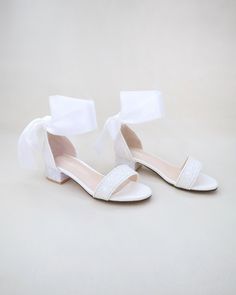 These sparkly rock glitter low block heel sandals with added satin ribbon ankle tie are perfect for flower girls, birthday, quinceañera, holiday parties and so much more. Include them in your everyday fancy attire to add a little pop of color and shine.  It is a great combination and will definitely be a favorite. DETAILS: HEEL HEIGHT: 1.25 inches COLORS AVAILABLE: White, Gold, Rose Gold, and Navy UPPER: Synthetic upper and lining MATERIALS: Manmade outsole STYLE NAME: MIA IMPORTANT NOTE: - Glit Shoes Costume, Birthday Shoes, Fancy Attire, Low Block Heel Sandal, Girls Heels, Costume Shoes, Block Heel Sandals, Low Block Heels, Girls Sandals