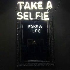 a neon sign that says fake a selfie