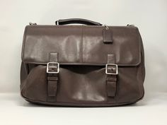 "Add timeless chicness to your professional ensemble. This COACH laptop bag is 100% leather with silver accents. With 10 pockets, it is easy to stay organized. Measuring at 15\" long, 4\" deep, and 10\" tall, it has plenty of room for your laptop of any size plus books and notebooks! Timeless Style The COACH laptop bag is still made and sold today. It's strength and simple style has a timelessness that will make it a staple in your closet for years to come.  WITHSTANDS MOVEMENT When racing to and from the subway or airport, enjoy peace of mind knowing that your laptop is insulated from hard bumps.  COMFORTABLE With a long, wide strap this vintage laptop bag can be swung over the shoulder or worn casually like a purse. SAY NO TO CHEAP RETAIL The bag has signs of wear, but lots of durability Vintage Laptop Bag, Leather Messenger Bag Laptop, Laptop Messenger Bags, Laptop Shoulder Bag, College Bags, Office Bag, Leather Coach, Leather Laptop, Laptop Bags