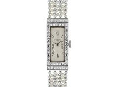 Art Deco Diamond and Natural Seed Pearl Watch in Platinum   The elongated rectangular ivory dial with Roman numerals, marked “J. Jarre”, within a French-cut diamond set bezel, to seven row gray and white seed pearl bracelet, with French-cut diamond spacer accents, the case engraved with Greek key and floral motifs. Movement signed M & W Ullmann. Pearl Watch, Art Deco Watch, Watches Rolex, Lipstick Case, Gold Watch Men, Jewellery Marketing, Expensive Watches, Antique Watches, Pearl Design