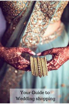 a woman with henna and bracelets on her hands