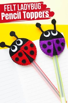 two felt ladybug pencil toppers sitting next to each other on a notebook