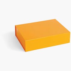 an orange box sitting on top of a white surface