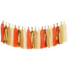 an orange and white tasselled garland with gold foil accents