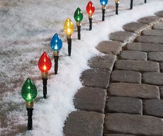 christmas lights are lined up in the snow on cobblestone pavement with text overlay reading $ 38 99 ebay