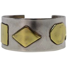 A fabulous artisan style piece, this cuff bracelet is made of .925 Sterling Silver and has contrasting Brass geometric appliques that bestows character and style. The mix metals cuff measures 2-1/4 inch by 2 inches and has an inside circumference of 7 inches including the one inch opening for an easy on and off. The width is 1-1/8 inch. In gift box. Yellow Gold Cuff Bracelet, Silver Bracelet Designs, Large Cuff Bracelet, Contemporary Bracelets, Diamond Cuff Bracelet, Crystal Cuff Bracelet, Modernist Jewelry, Wide Cuff Bracelets, Wood Bracelet